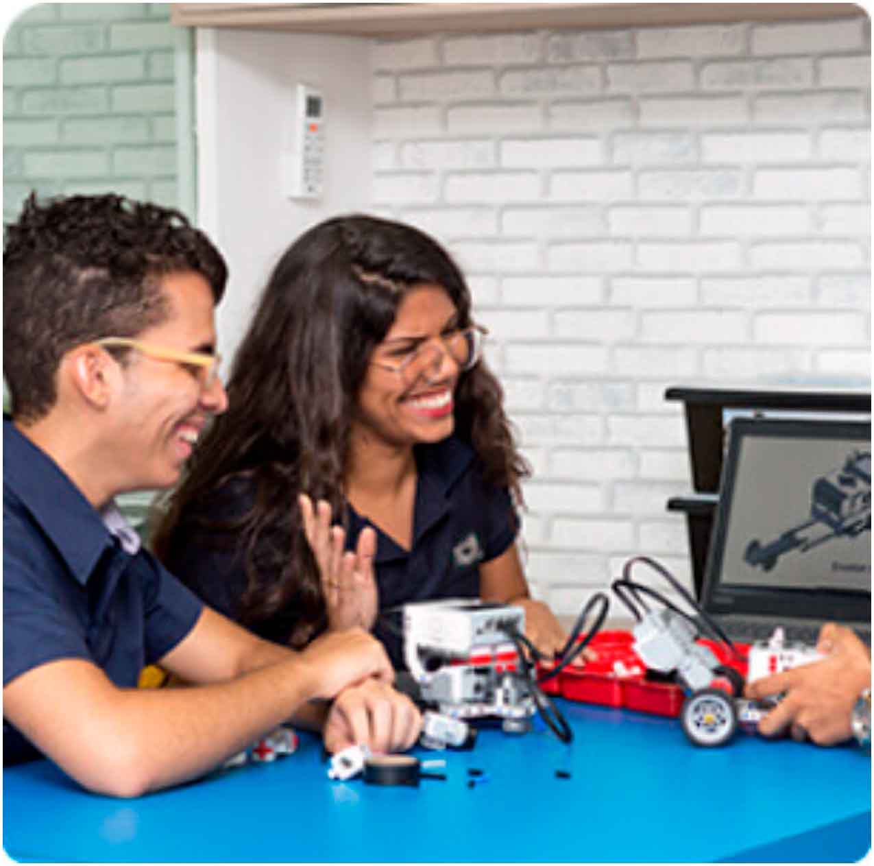 duas crianças montando uma casinha com peça de papelão